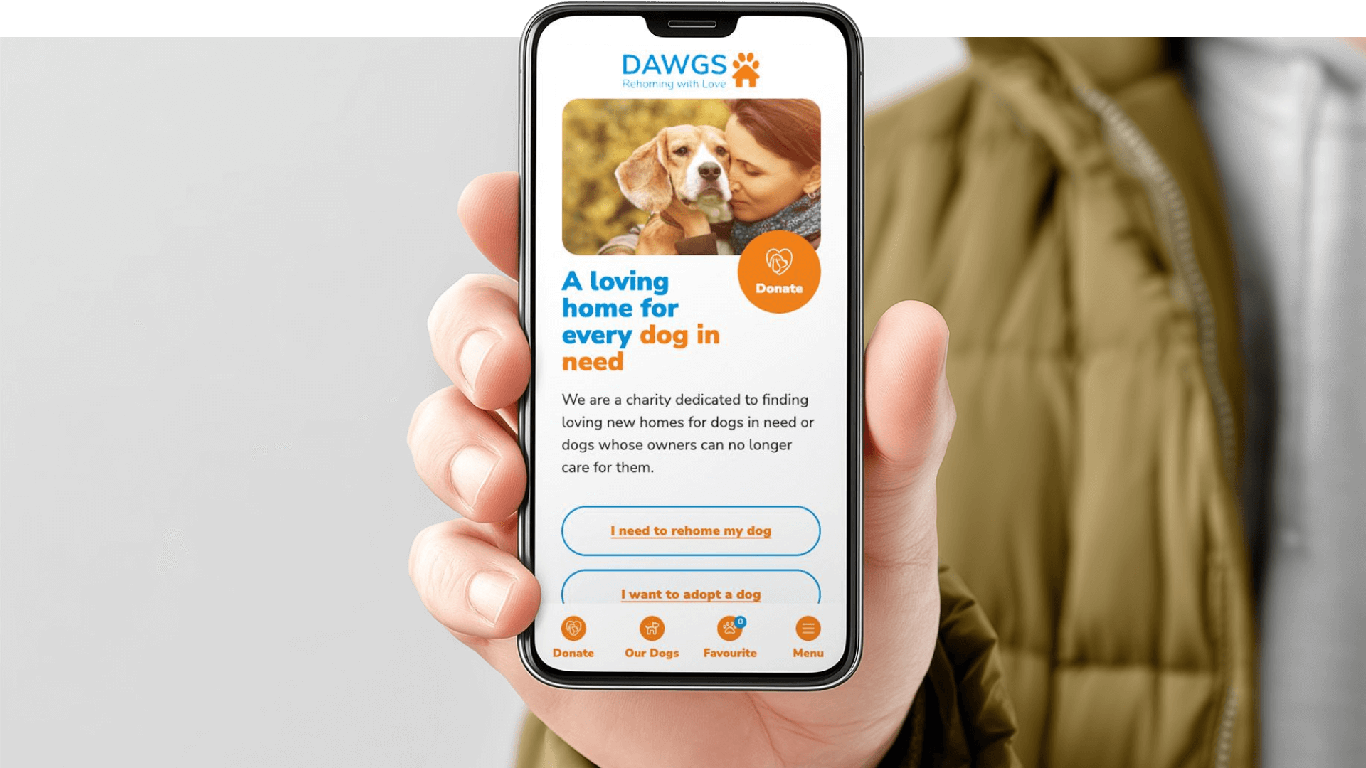 A person holding a mobile phone showcasing the DAWGS website