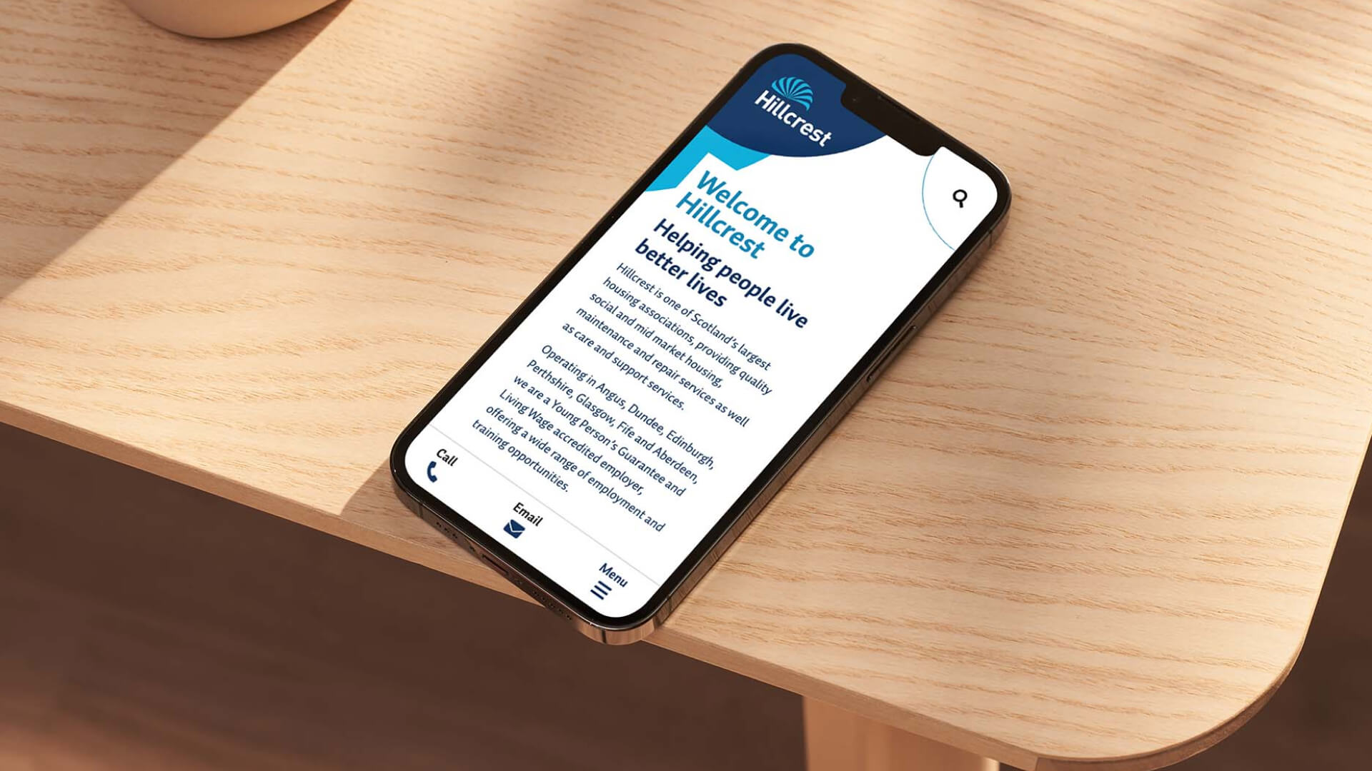A mobile phone showcasing the Hillcrest website