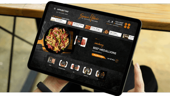 A tablet showcasing the Simon Howie website