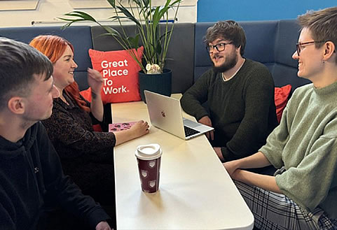 Altar employees gathered in one of the office booths