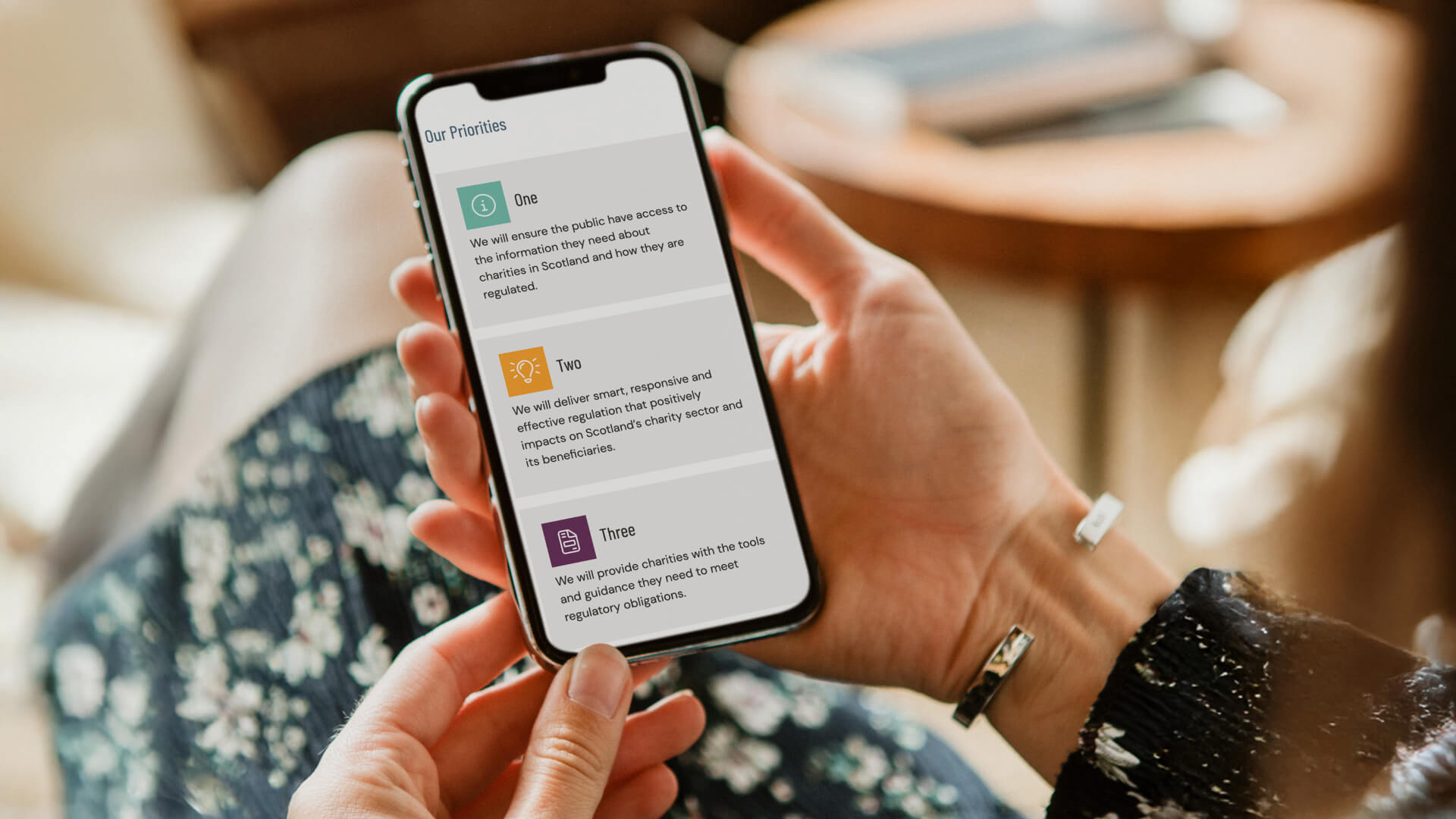 A mobile phone showcasing the OSCR website