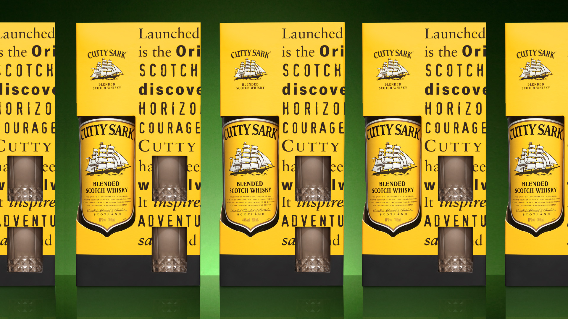 Display of multiple Cutty Sark packaging with two glasses and a bottle of Cutty Sark