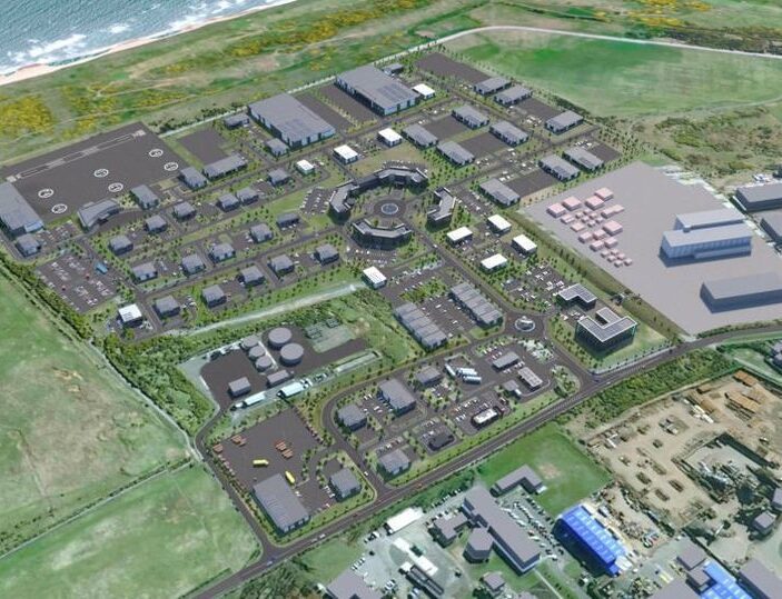 An aerial digital rendering of a large, organized business park development near a coastline, showing numerous grey commercial buildings, parking lots, and green landscaping.