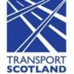 The Transport Scotland logo, featuring a blue square icon containing intersecting white lines that resemble roads or tracks forming a stylized Saltire, with the text "TRANSPORT SCOTLAND" in blue capital letters underneath.