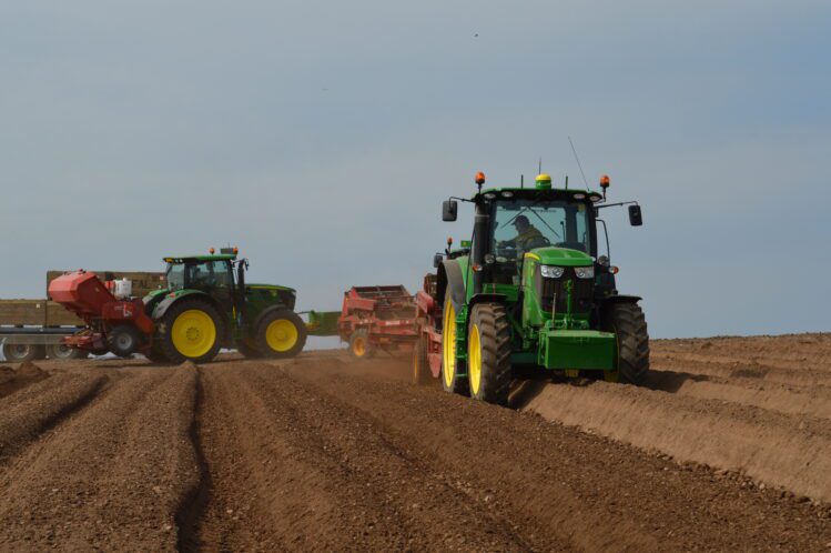 Tractors in a field representing agritech