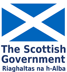 The logo for The Scottish Government, featuring a blue and white stylized Saltire (the national flag of Scotland) at the top. Below the flag, the text "The Scottish Government" is written in a bold, navy blue sans-serif font, followed by the Gaelic name "Riaghaltas na h-Alba" in a smaller weight.