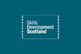 The white text "Skills Development Scotland" enclosed in a thin rectangular border with perforated edges, set against a solid teal background.