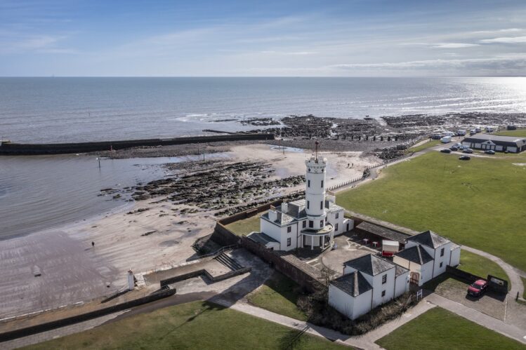 Aerial view of Arbroath Signal Tower Museum with the sea in the background.