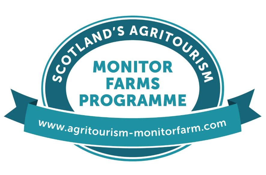 A circular teal and white logo for "Scotland's Agritourism Monitor Farms Programme" featuring a ribbon banner across the bottom with the website address www.agritourism-monitorfarm.com.