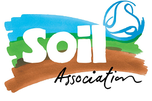 The logo for the Soil Association, featuring the word "Soil" in large white lowercase letters and "Association" in black cursive script below. The text is set against a background of watercolor-style brushstrokes in blue, green, and brown, with a blue circular swirl emblem in the top right corner.