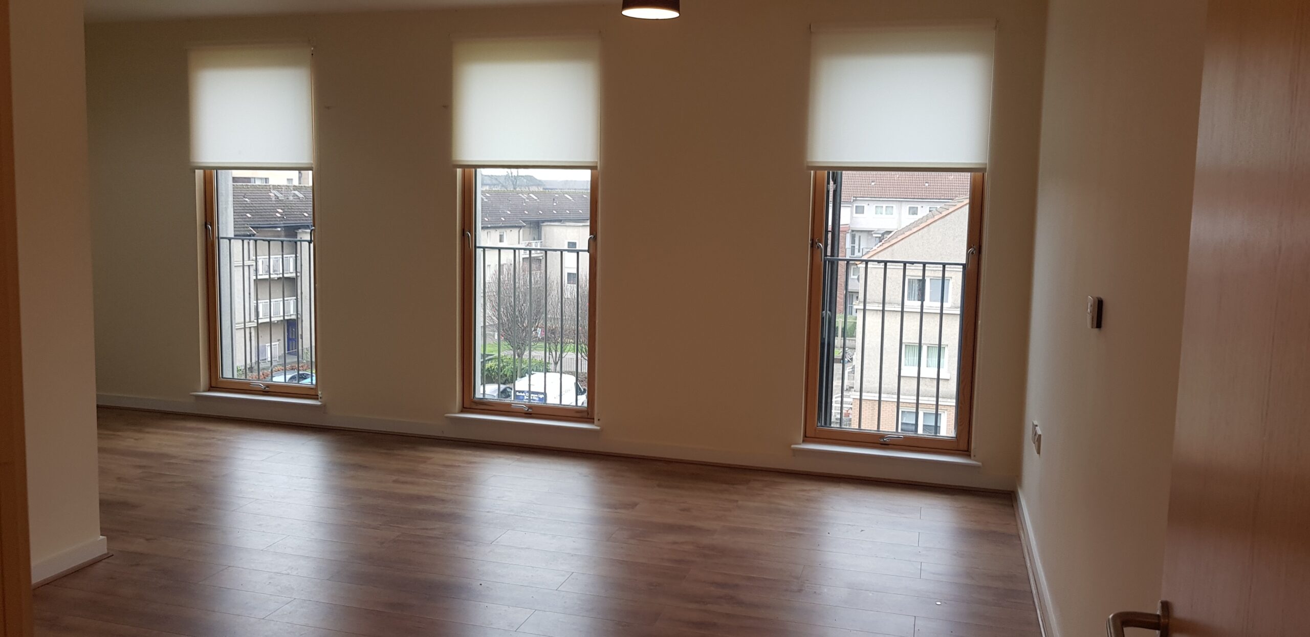 living room interior shot, white walls, window and grey flooring - ballater place