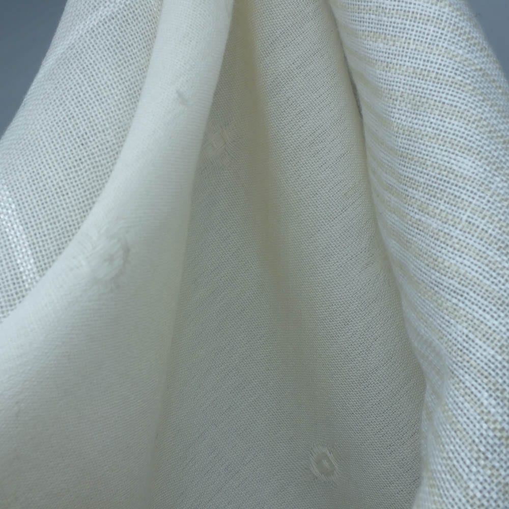 Simplice Collection Cover Image - draped sheer and lightweight cream fabrics with subtle woven textures and small embroidered dots.