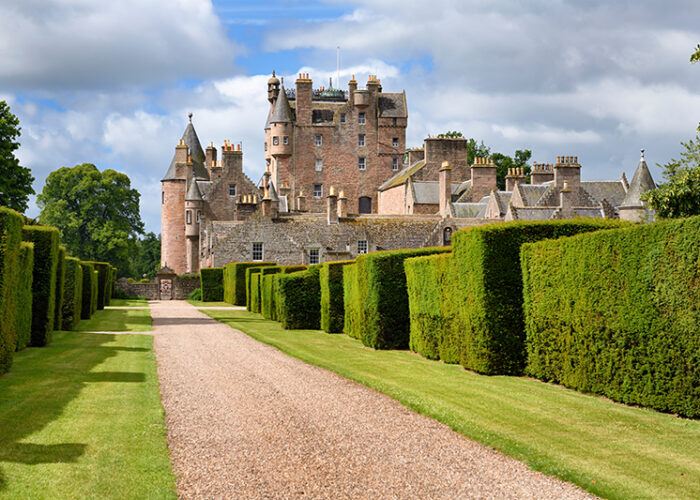 Red stone path with yew hedges in east Italian Garden of Glamis