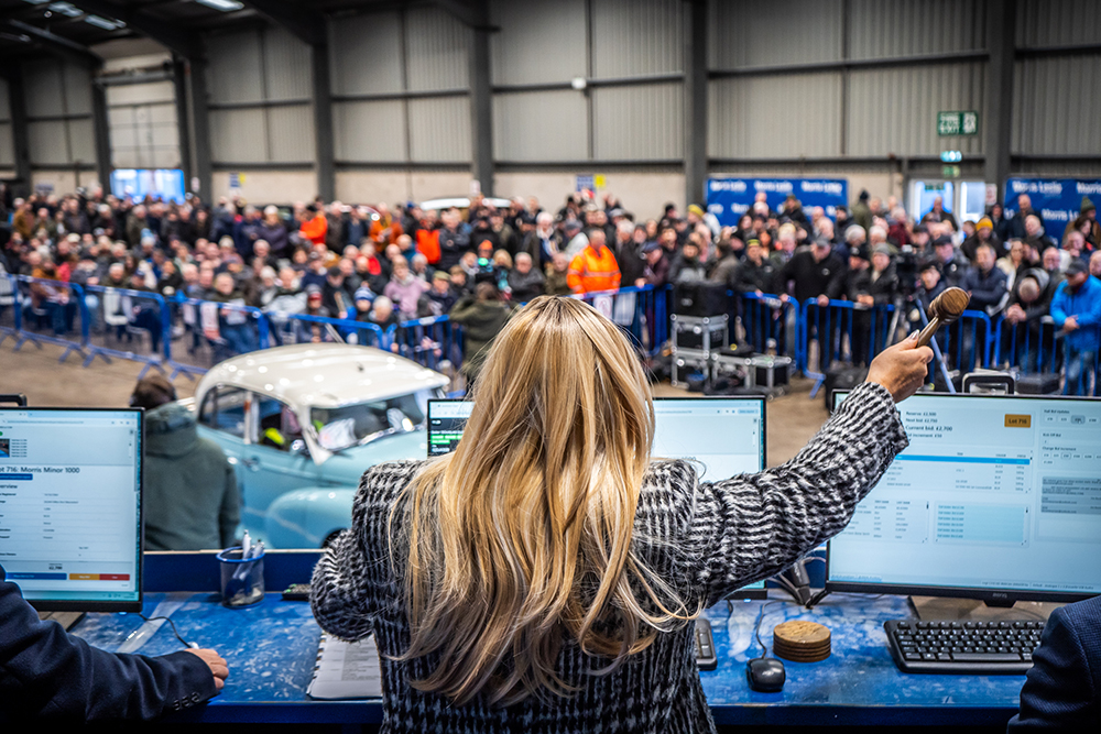 Auctioneers on the rostrum at Morris Leslie Auctions' February Classic Sale 2026, featuring a car featured in the BAFTA award winning movie I SWEAR