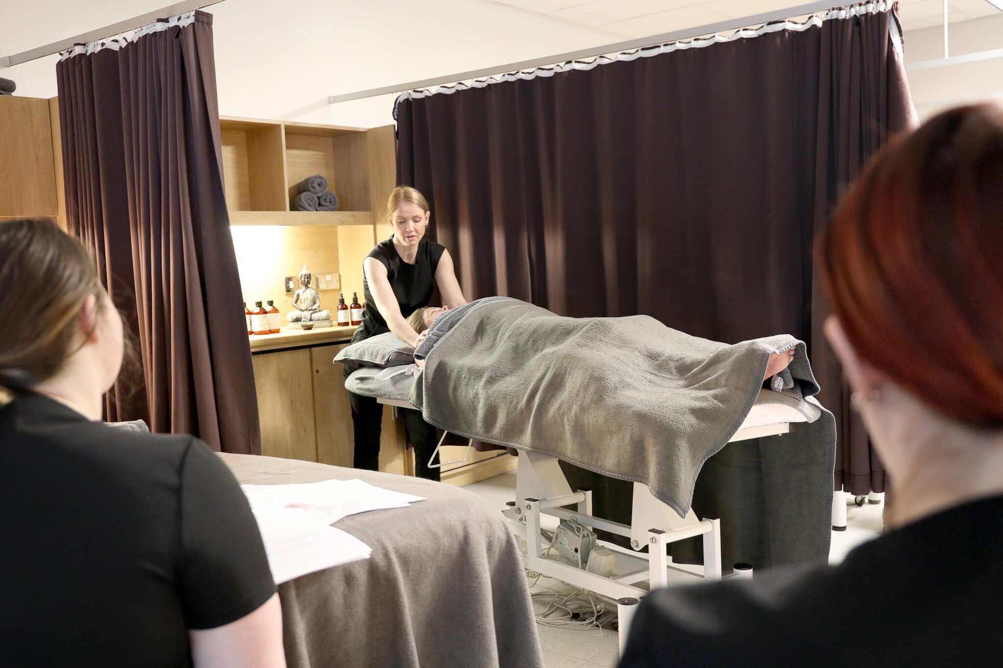 Lecturer demonstrating a beauty therapy treatment