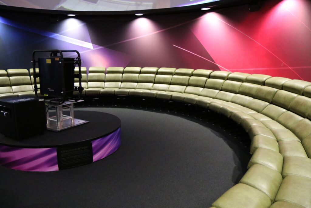 NESCol's Planetarium reclined seating, with projector in the middle of the room.