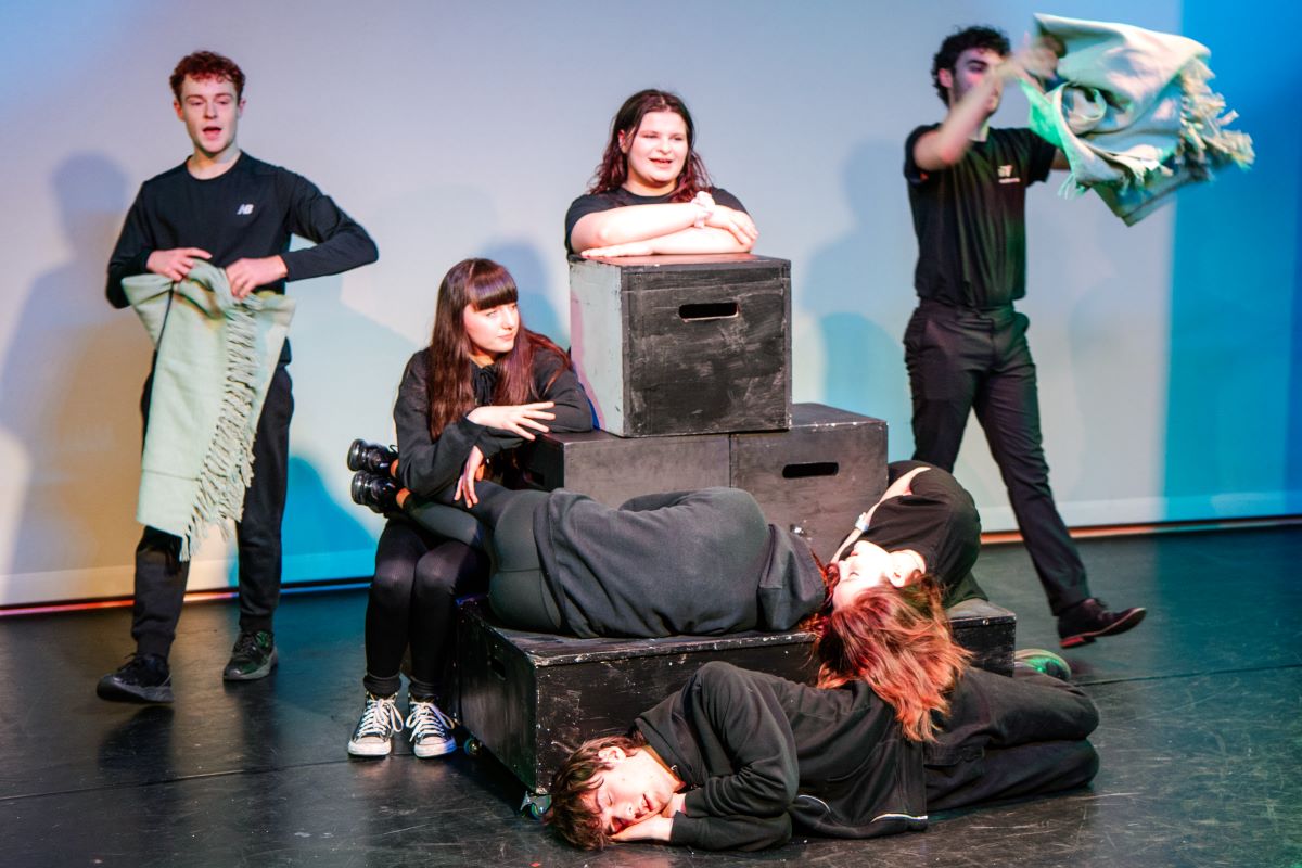 Students with props in the basement theatre