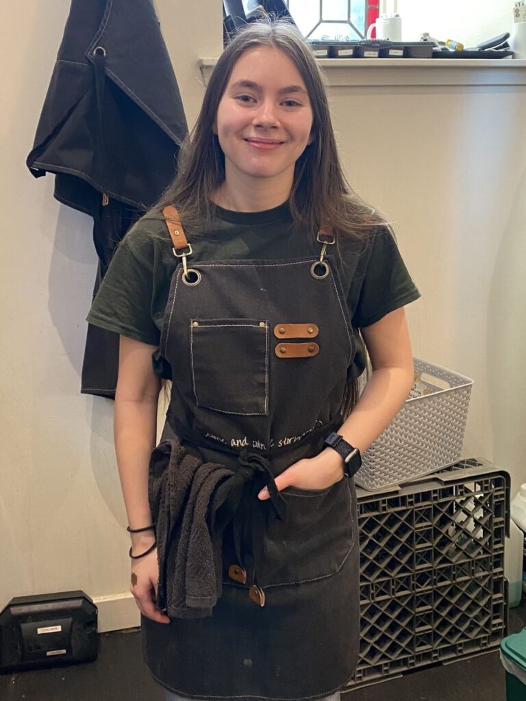 Edai smiling in an apron.