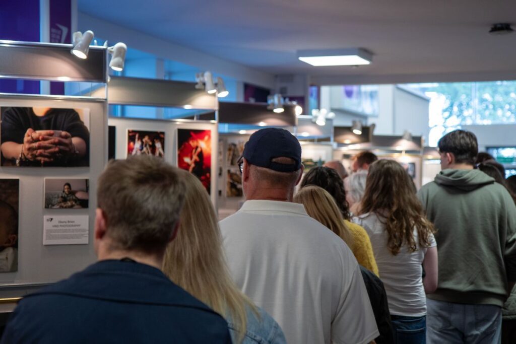 Crowd looking at student art exhibition