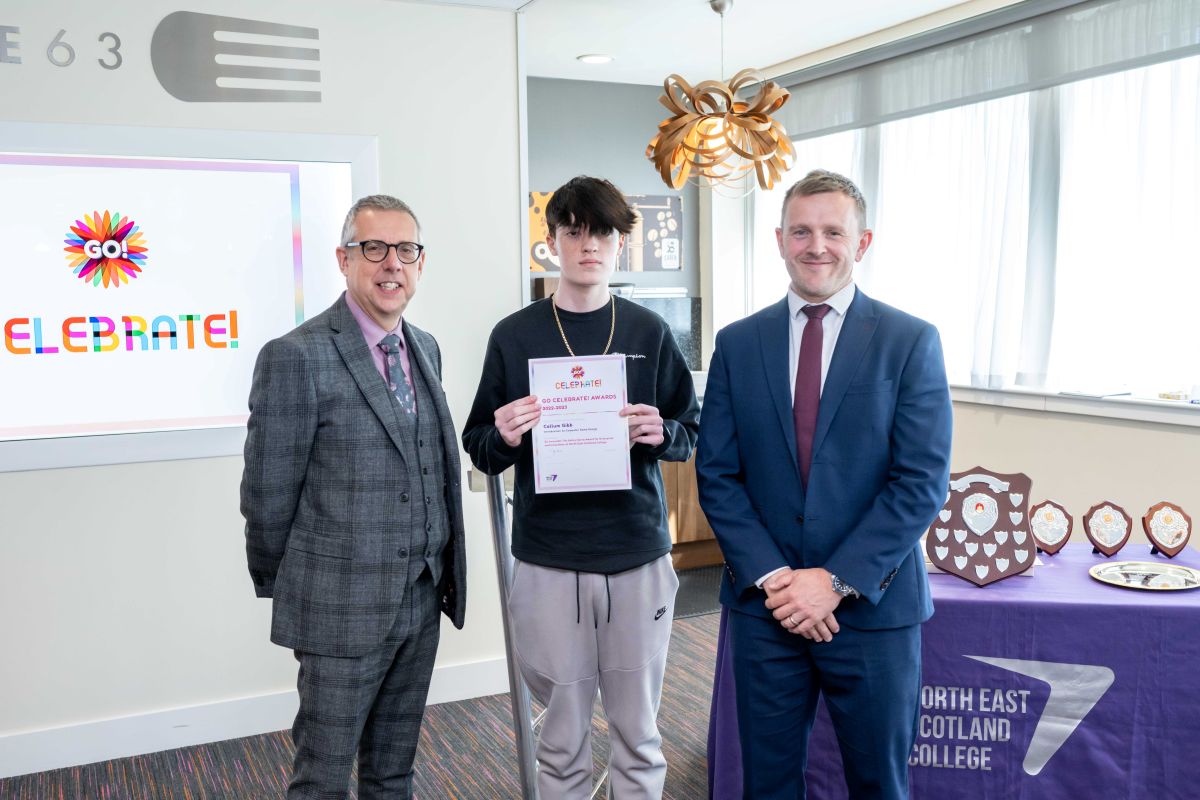 Callum holding his certificate next to NESCol Principal Neil Cowie and Vice Principal Robin McGregor.