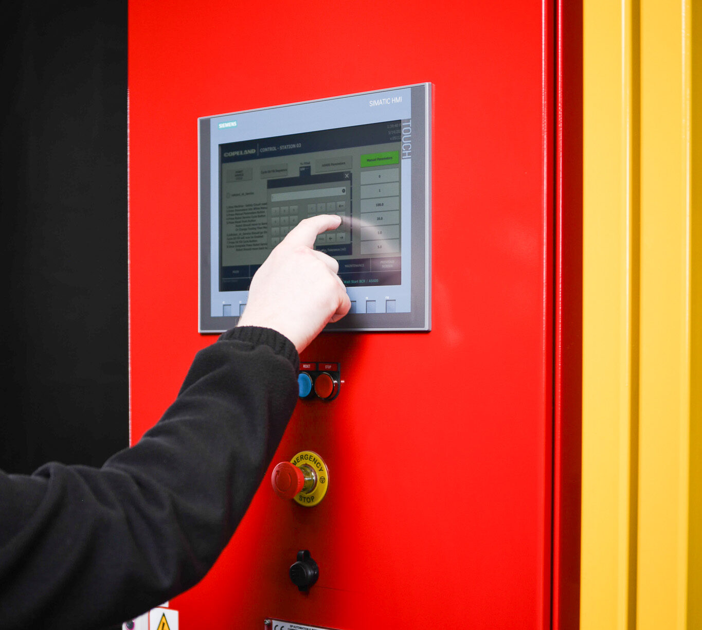 Person using the touch screen on an automation system