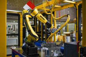 Large Fanuc robot in a safety cage