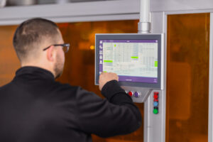 Machine operator using a touch screen panel.