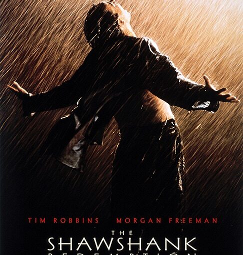A movie poster for "The Shawshank Redemption." The poster is dark and moody, with a silhouette of a man standing in the pouring rain, arms outstretched and head tilted back. Above him, the text reads "FEAR CAN HOLD YOU PRISONER. HOPE CAN SET YOU FREE." Below the main image, the names Tim Robbins and Morgan Freeman are visible, followed by the movie's title in large letters. The bottom of the poster contains smaller text listing the cast and crew.