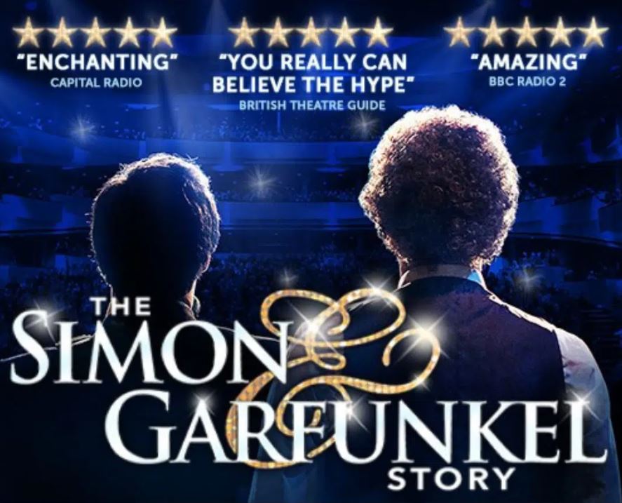 A promotional poster for "The Simon & Garfunkel Story," featuring the backs of two men (representing the artists) on a stage bathed in blue light. The title "THE SIMON & GARFUNKEL STORY" is in large, sparkling white and gold text at the bottom. Above the stage are three separate five-star review snippets with citations from Capital Radio, British Theatre Guide, and BBC Radio 2.