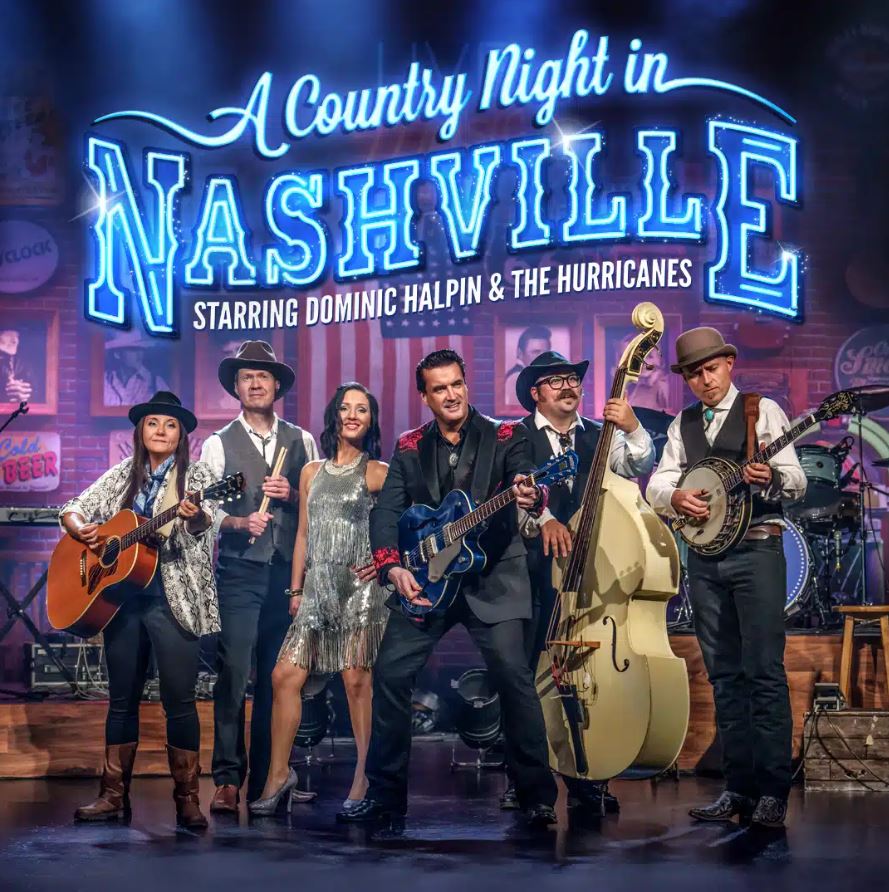 Six musicians, including a central male singer with a blue electric guitar, standing on a stage with instruments like a banjo, acoustic guitar, and upright bass, beneath a neon sign that reads "A Country Night in Nashville starring Dominic Halpin & The Hurricanes."