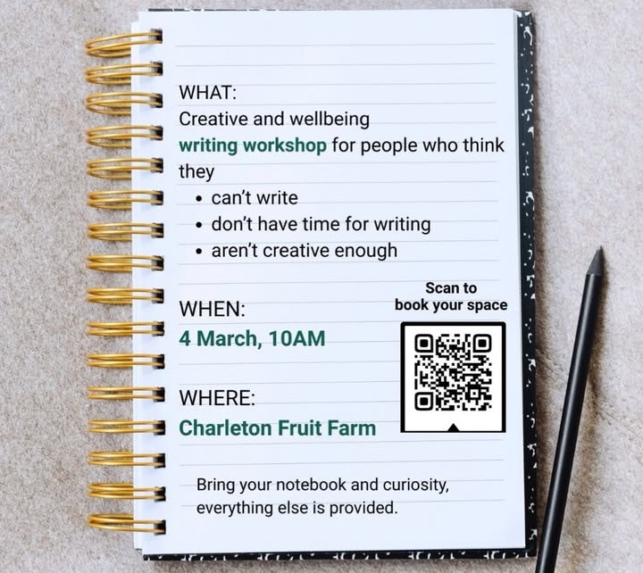 A gold spiral-bound notebook lies open on a textured gray surface with a black pencil beside it. The lined page contains details for a "Creative and wellbeing writing workshop" intended for those who feel they can't write or aren't creative. The event is scheduled for 4 March at 10 AM at Charleton Fruit Farm, and includes a QR code to scan for bookings.