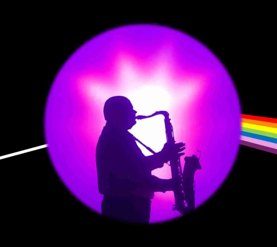 A silhouette of a person playing a saxophone is centered within a glowing purple circle against a black background. A thin white light enters from the left and exits on the right as a vibrant rainbow beam, evoking the iconic "Dark Side of the Moon" prism imagery.