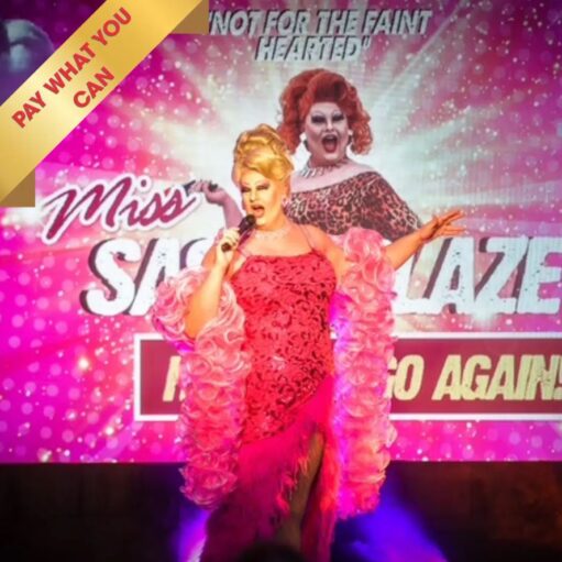 A promotional graphic for a drag performance titled "Miss Sasha Blaze... Here We Go Again!" featuring two images of a drag queen with voluminous hair and glamorous makeup. One figure stands in the foreground wearing a pink sequined dress and a ruffled pink feather boa while holding a microphone, while a second version of the performer appears in the background in a leopard print outfit. The background is a vibrant pink with sparkling light effects, and a yellow banner in the top left corner reads "PAY WHAT YOU CAN."