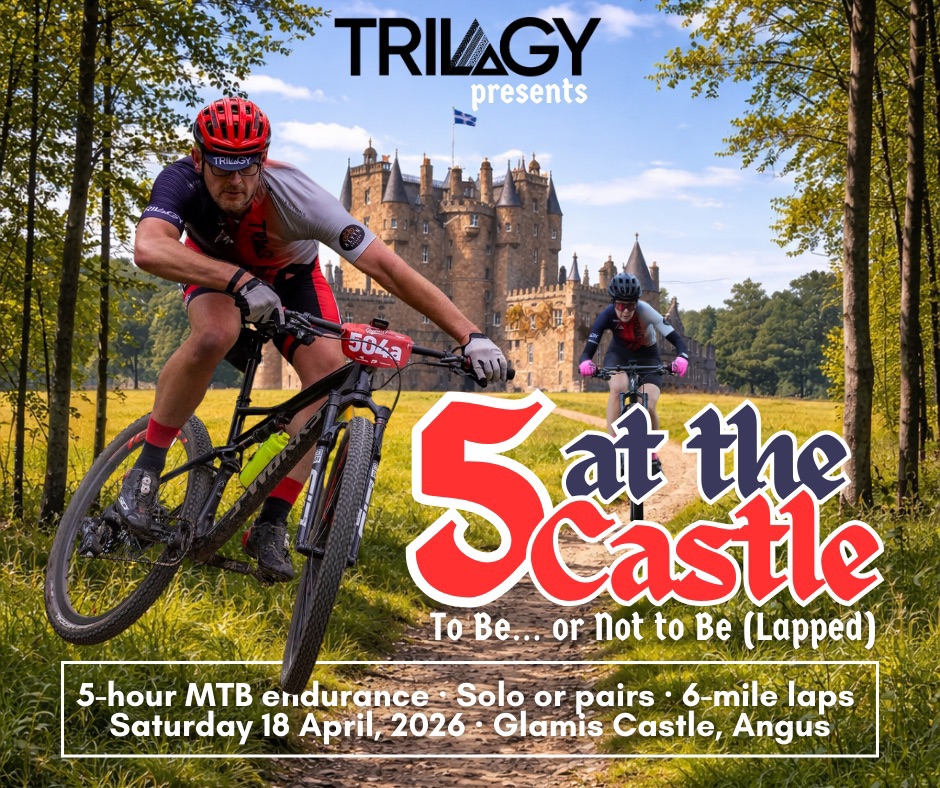 An event poster for "5 at the Castle," a mountain bike endurance race presented by Trilogy. The image features two cyclists in athletic gear racing down a dirt trail with the historic, turreted Glamis Castle in the background. Bold red and white text reads "5 at the Castle: To Be… or Not to Be (Lapped)." Details at the bottom specify a 5-hour MTB endurance event with solo or pair options and 6-mile laps, taking place on Saturday, 18 April, 2026, at Glamis Castle, Angus.
