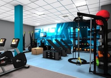Modern fitness suite at Brechin Community Campus featuring cardio machines, weight benches, functional training equipment, suspension straps and free weights, with bright blue accents and a large fitness-themed wall graphic.