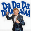 Promotional image featuring a performer in a patterned blue dinner jacket holding two conducting batons, one raised and the other held forward, against a white background. Large bold blue text behind the performer reads “Da Da Da Da.” The clean, high-contrast design creates a playful and energetic visual style, suggesting a music, comedy or orchestral-themed live performance centred on conducting and classical music.