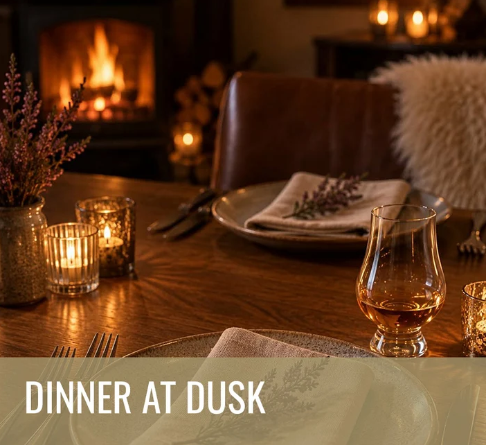 Cosy candlelit dining table set beside a glowing fireplace, featuring elegant place settings and a glass of whisky, with the text “Dinner at Dusk” displayed across the image.