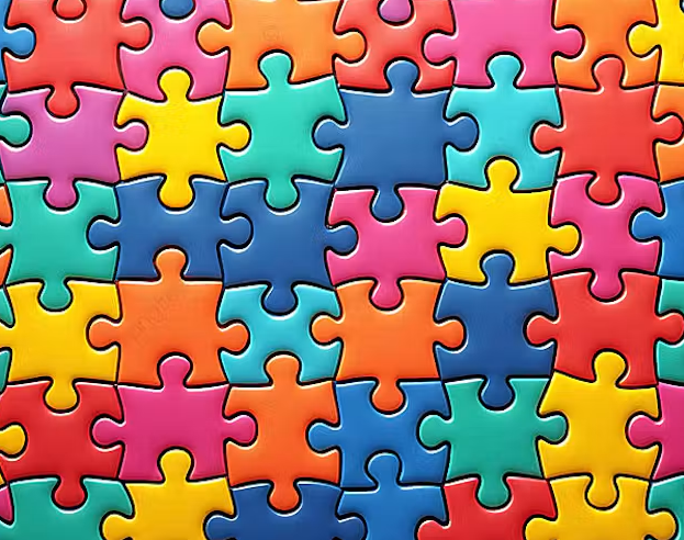 Colourful close-up image of interlocking jigsaw puzzle pieces in bright shades of blue, pink, yellow, orange and green, arranged to fill the entire frame in a repeating pattern.